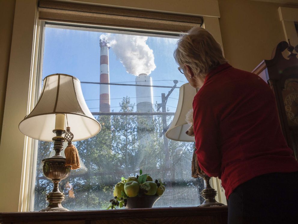 PHOTO: Marti Blake looks out her front window at the smoke stack of the 47-year old Cheswick coal-fired power plant, Oct. 27, 2017 in Springdale, Pa.