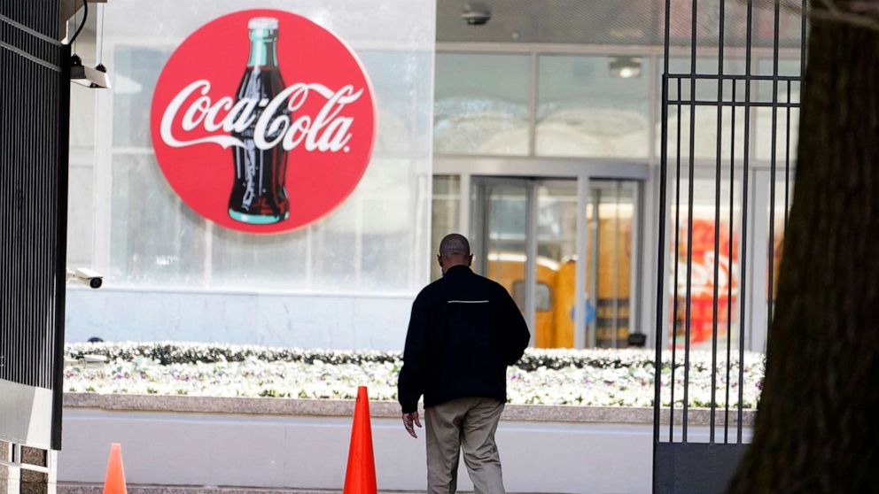 PHOTO: A man walks near the entrance for Coca-Cola headquarters Friday, Feb. 5, 2021, in Atlanta.