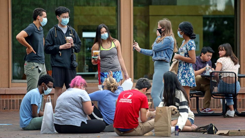 PHOTO: Students gather outdoors at the Tufts campus center in Medford, Mass., Aug. 27, 2020.