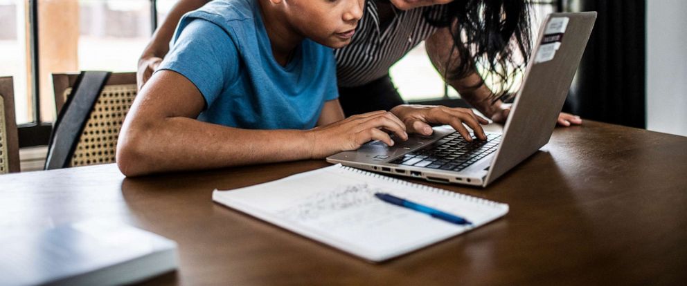 PHOTO: A mother helps her son on a computer in an undated stock photo. 