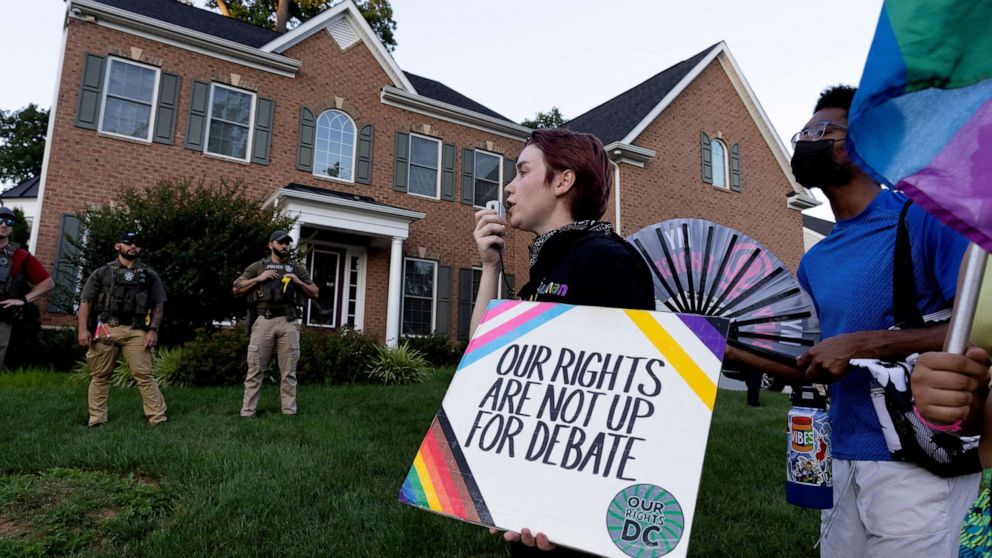 PHOTO: US Marshals watch abortion rights activists march outside the home of conservative Supreme Court Justice Amy Coney Barrett, in Falls Church, Va., June 30, 2022.