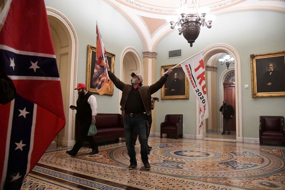 PHOTO: Supporters of President Donald Trump wave Trump flags and Confederate battle flags as they demonstrate on the second floor of the U.S. Capitol near the entrance to the Senate after breaching security defenses, in Washington, D.C., Jan. 6, 2021.