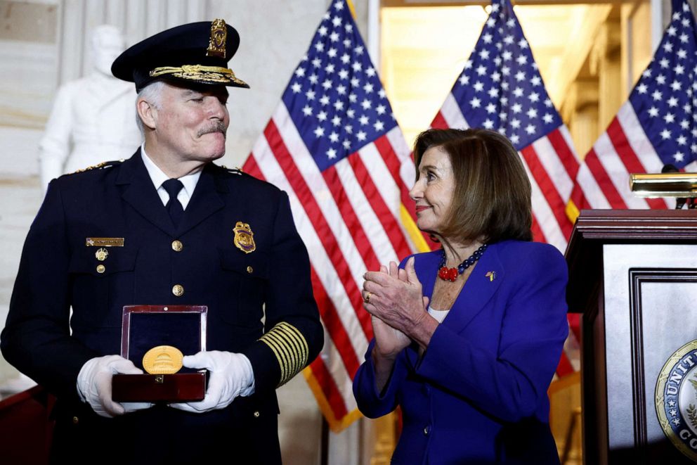 U.S. Capitol Police Chief Thomas Manger receives a medal from House Speaker Nancy Pelosi at a Congressional Gold Medal Ceremony, honoring thos who protected the U.S. Capitol on Jan. 6, 2021, in the U.S. Capitol rotunda in Washington, Dec. 6, 2022.