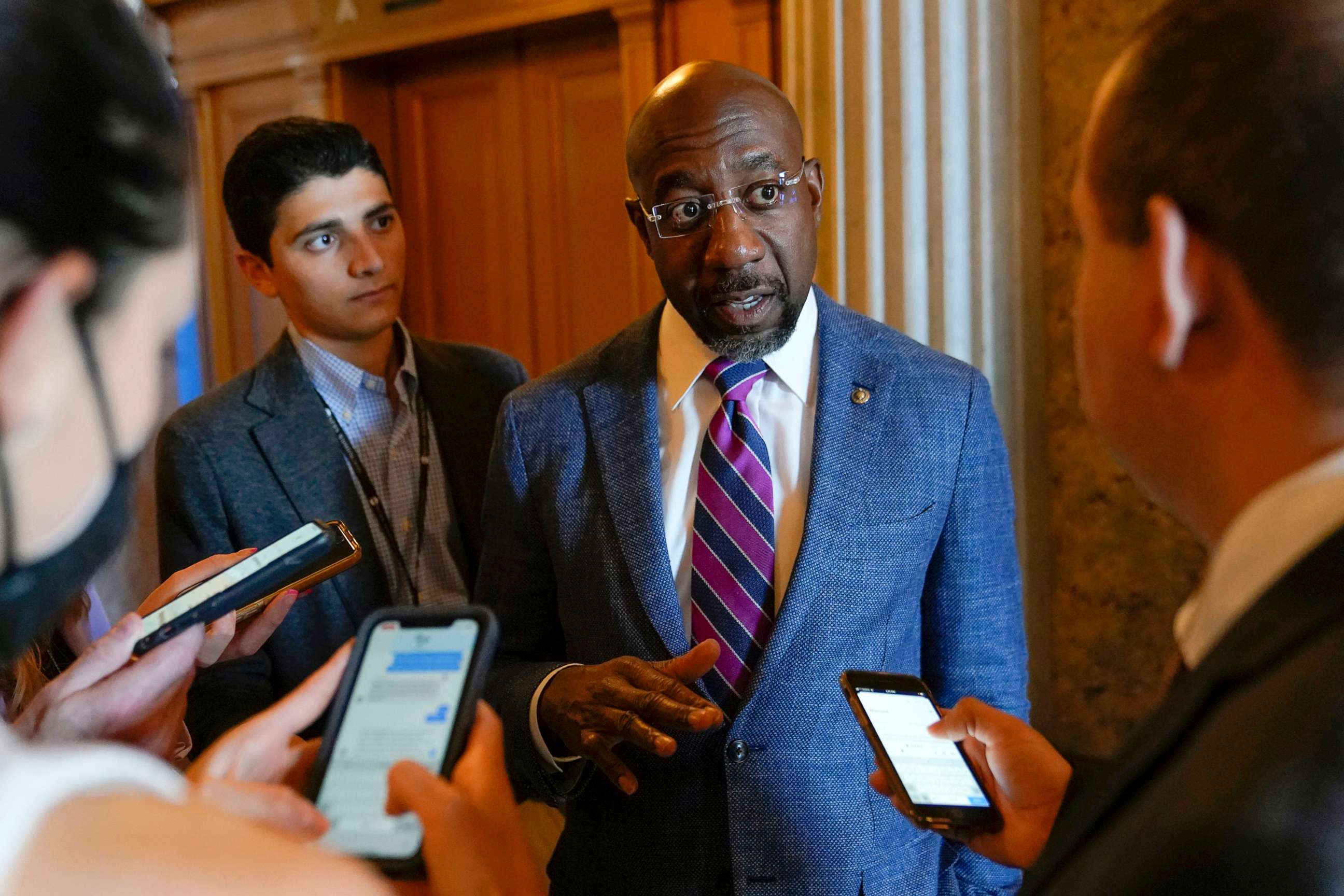 PHOTO: Sen. Raphael Warnock speaks with reporters on Capitol Hill in Washington, Aug. 6, 2022.