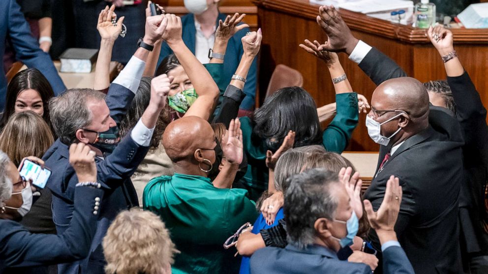 PHOTO: Democrats celebrate in the chamber as the House approves a sweeping social and environment bill, giving a victory to President Joe Biden, at the Capitol in Washington, Nov. 19, 2021.
