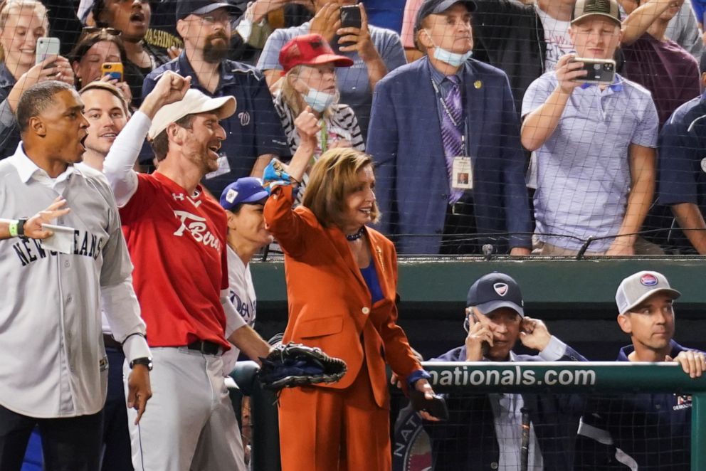 PHOTO: House Speaker Nancy Pelosi reacts while President Joe Biden uses a cellphone during the annual Congressional Baseball Game at Nationals Park in Washington, D.C., Sept. 29, 2021. 