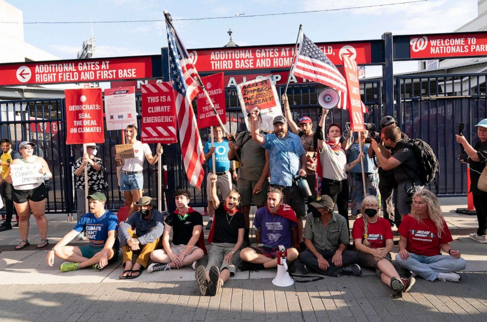 PHOTO: Climate activists protest outside Nationals Park, where the annual Congressional Baseball Game for Charity is being held in Washington, July 28, 2022.