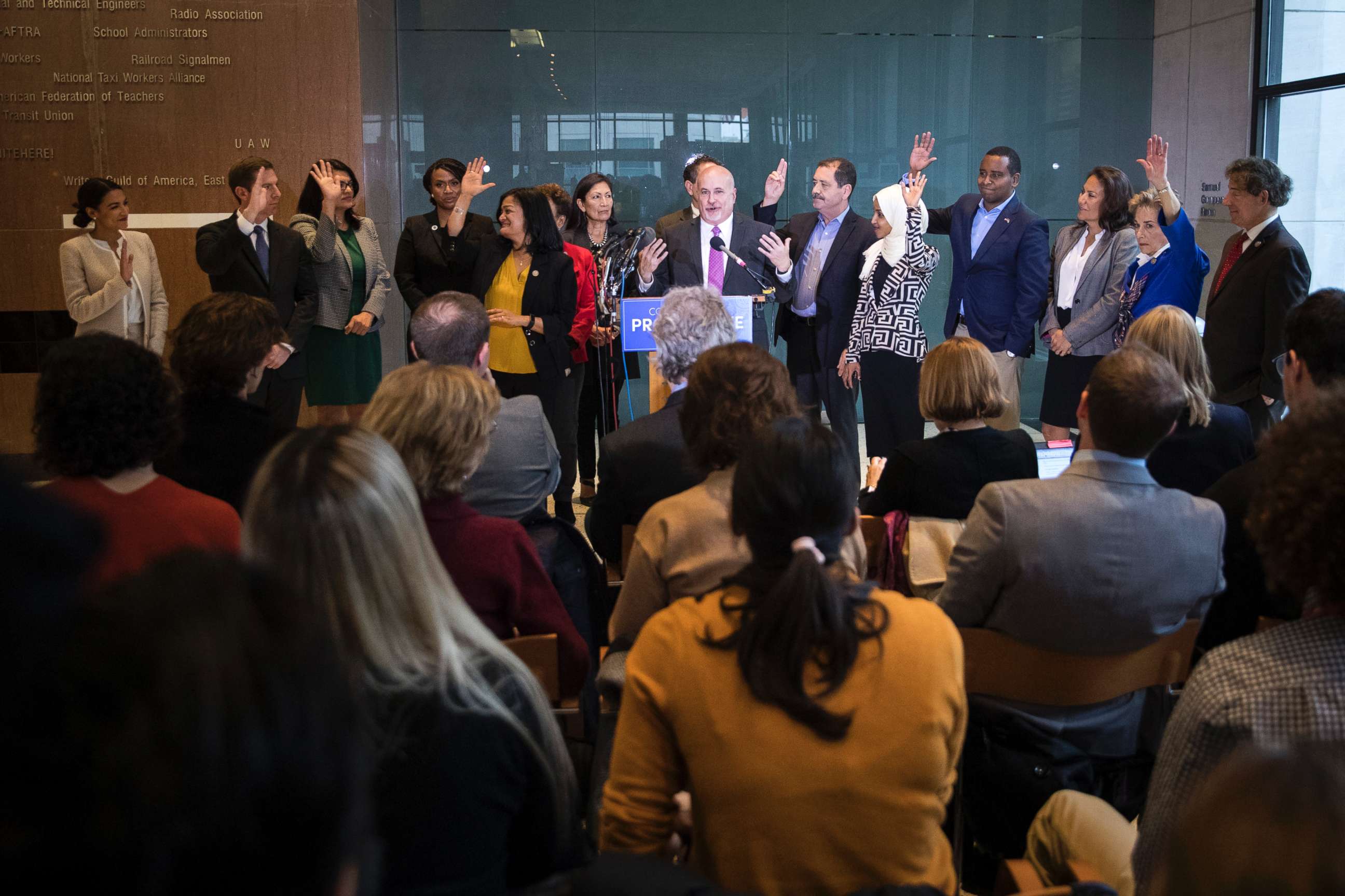 PHOTO: Incoming Democratic members of the House raise their hands at a Congressional Progressive Caucus news conference at the AFL-CIO International Headquarters in Washington, Nov. 12, 2018.