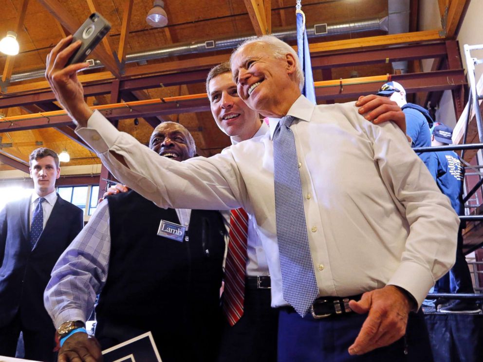 PHOTO: Conor Lamb, center, the Democratic candidate for the March 13 special election in Pennsylvanias 18th Congressional District, and former Vice President Joe Biden pose for a selfie with a supporter during a rally in Collier, Pa., March 6, 2018.