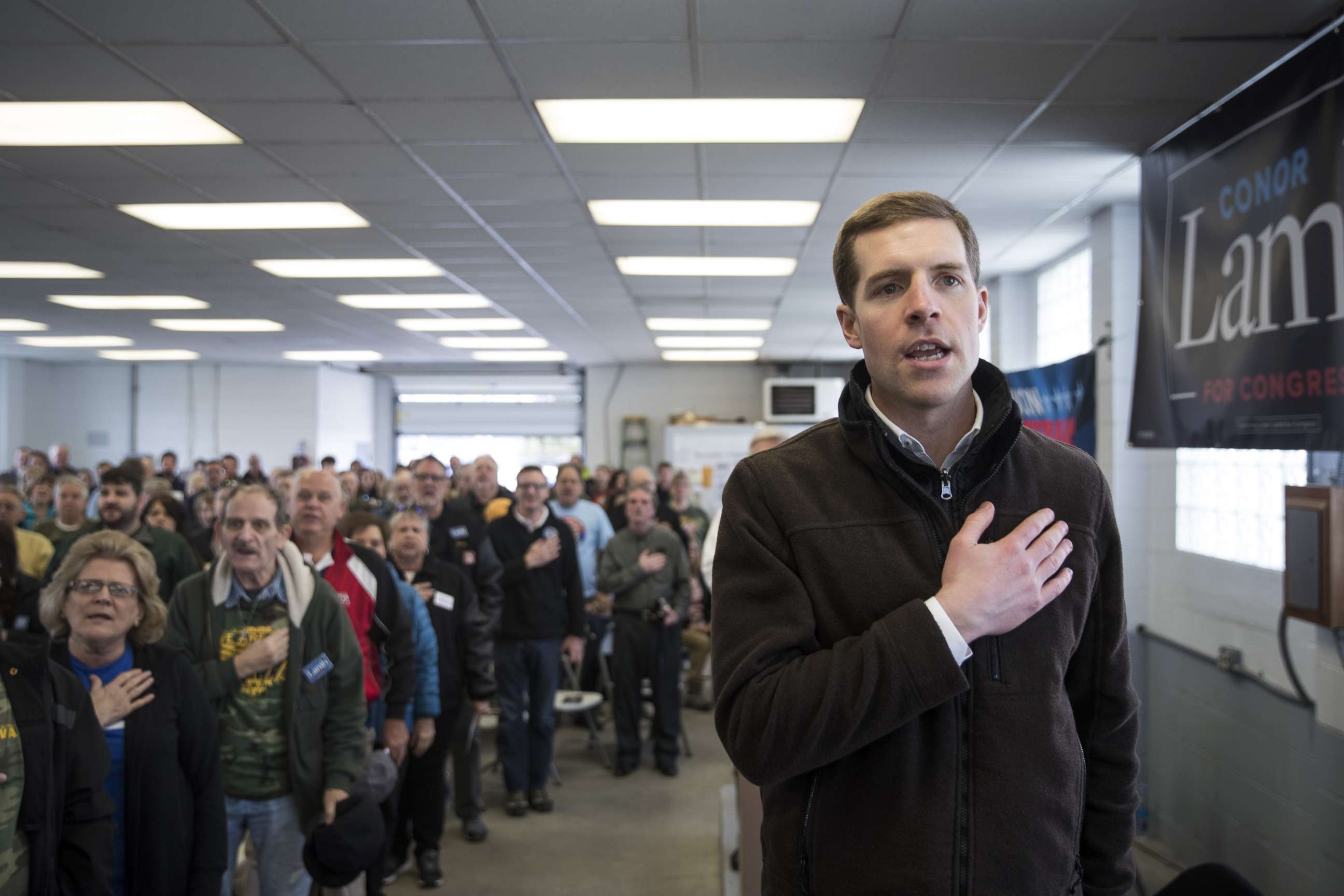 PHOTO: Conor Lamb, Democratic Congressional candidate for Pennsylvania's 18th district, and the audience recite the Pledge of Allegiance during a campaign rally with United Mine Workers of America (UMWA), March 11, 2018, in Waynesburg, Penn.