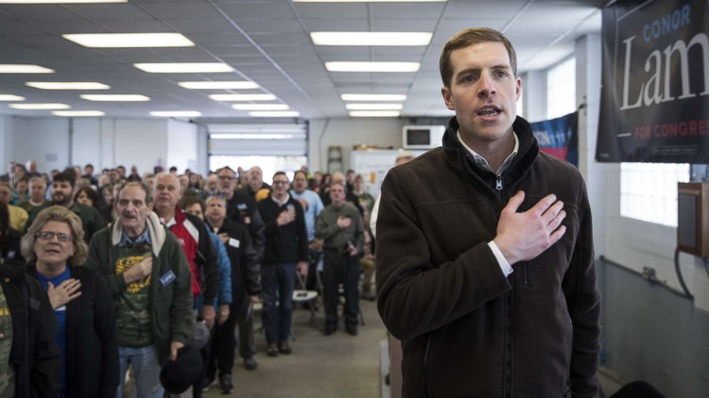 PHOTO: Conor Lamb, Democratic Congressional candidate for Pennsylvania's 18th district, and the audience recite the Pledge of Allegiance during a campaign rally with United Mine Workers of America (UMWA), March 11, 2018, in Waynesburg, Penn.