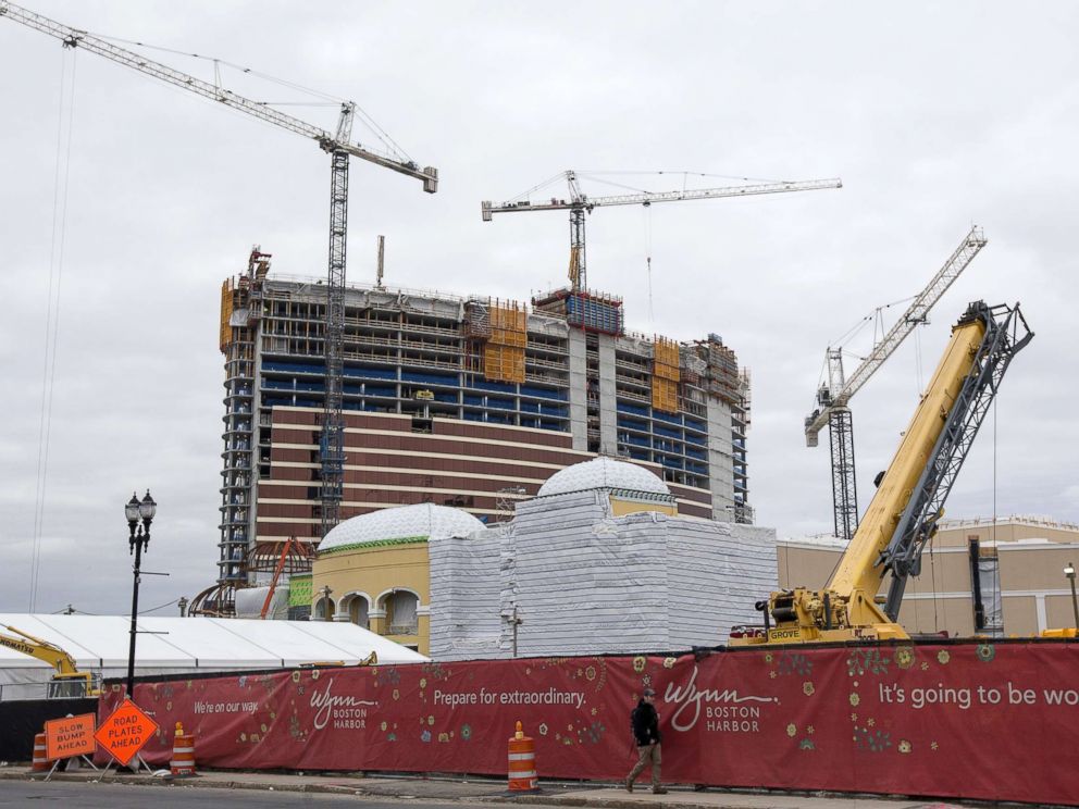 PHOTO: A pedestrian walks past the Wynn Boston Harbor Resort Casino under construction in Everett, Mass., Feb. 7, 2018.