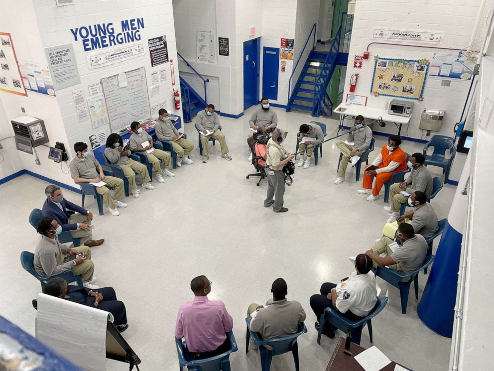 PHOTO:  Inmates in the Young Men Emerging mentorship program at D.C. jail study economics and personal finance with Joel Caston, the program's founder and a convicted felon.
