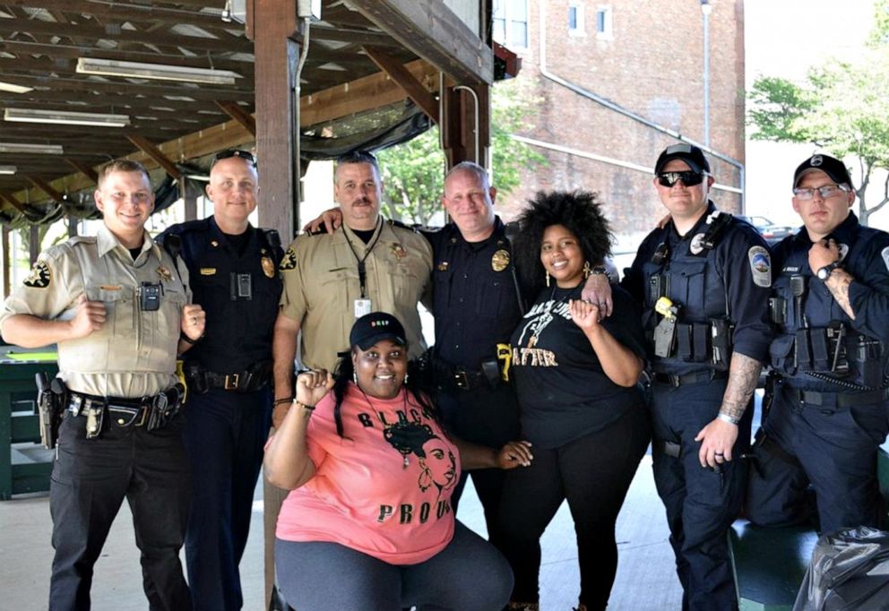 PHOTO: Rocky Mount police officers stand in solidarity with local African American residents at the town's first Black Lives Matter protest in June 2020.