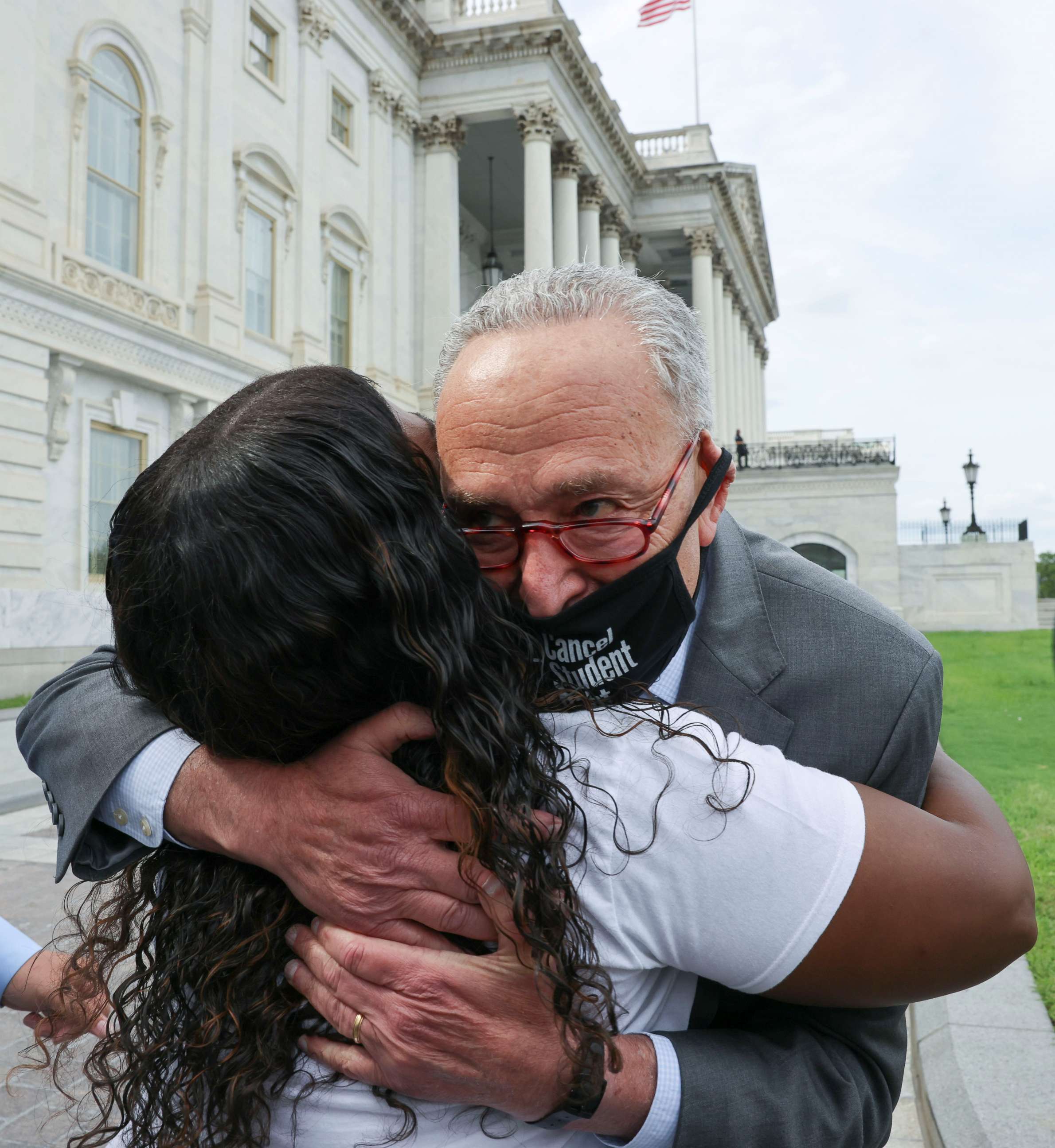 PHOTO: Senate Majority Leader Chuck Schumer hugs Rep. Cori Bush as they celebrate news that the White House intends to extend the eviction moratorium, outside the U.S. Capitol Building on Capitol Hill in Washington, Aug. 3, 2021.