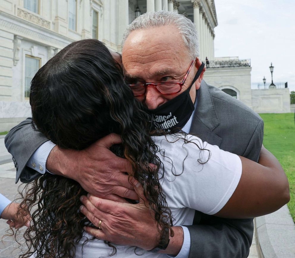 PHOTO: Senate Majority Leader Chuck Schumer hugs Rep. Cori Bush as they celebrate news that the White House intends to extend the eviction moratorium, outside the U.S. Capitol Building on Capitol Hill in Washington, Aug. 3, 2021.