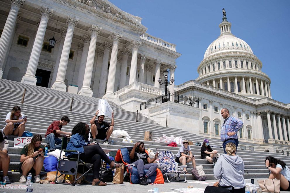 Rep. Cori Bush, D-Mo., holds up her on July 31, 2021 phone while live streaming from where she spent the night on the steps of the U.S. Capitol to highlight the upcoming expiration of the pandemic-related federal moratorium on residential evictions.