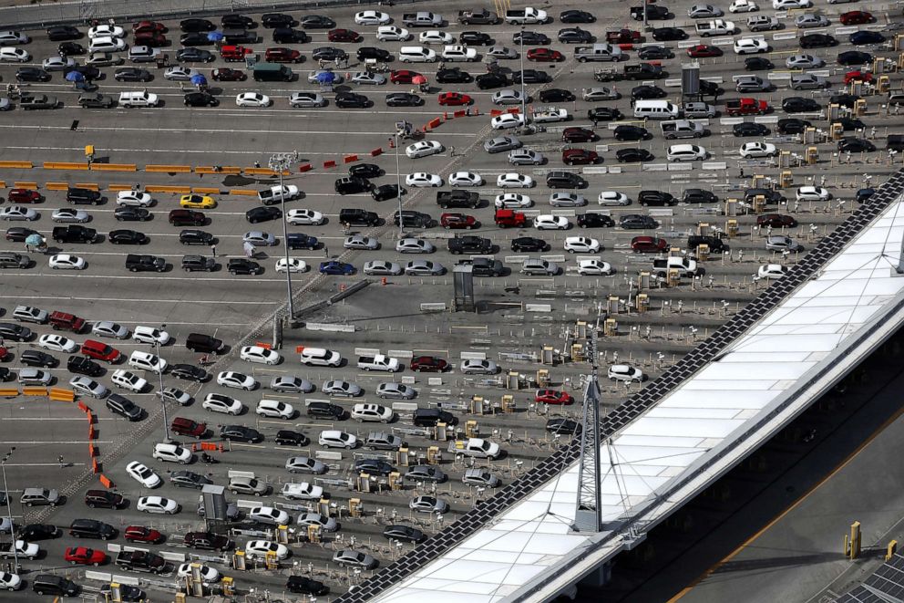 PHOTO: Motorists line up to cross into the United States from Mexico through the U.S. Customs and Border Protection - San Ysidro Port of Entry during the coronavirus pandemic on March 20, 2020, in San Diego.