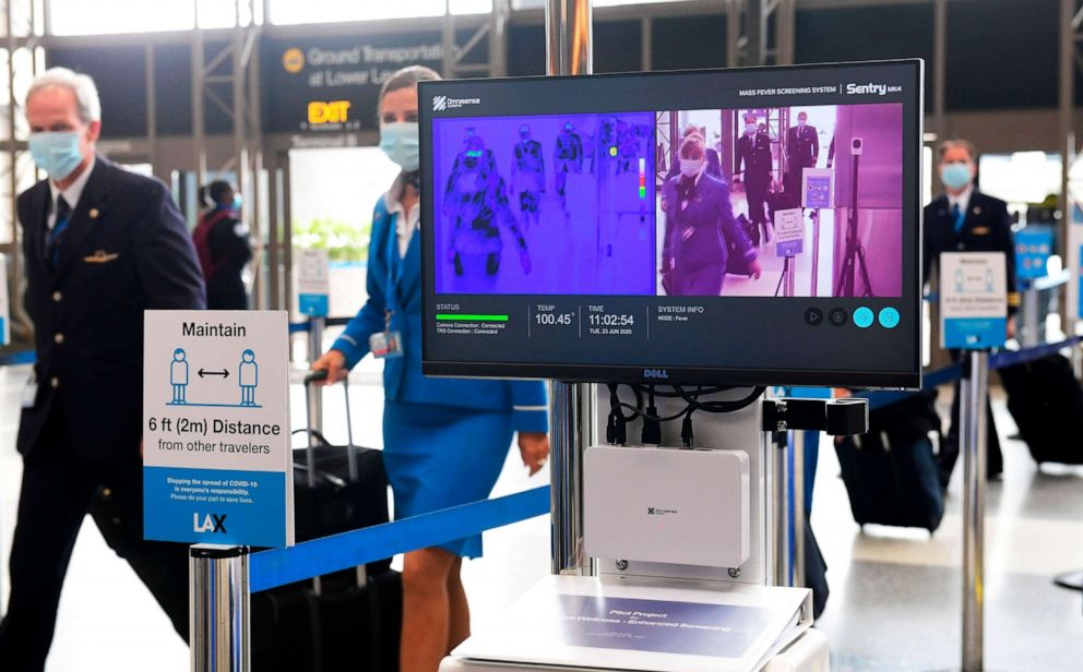 PHOTO: Flight crew walk past thermal cameras, that check passenger's body temperatures, at Los Angeles International Airport in Los Angeles, June 23, 2020.