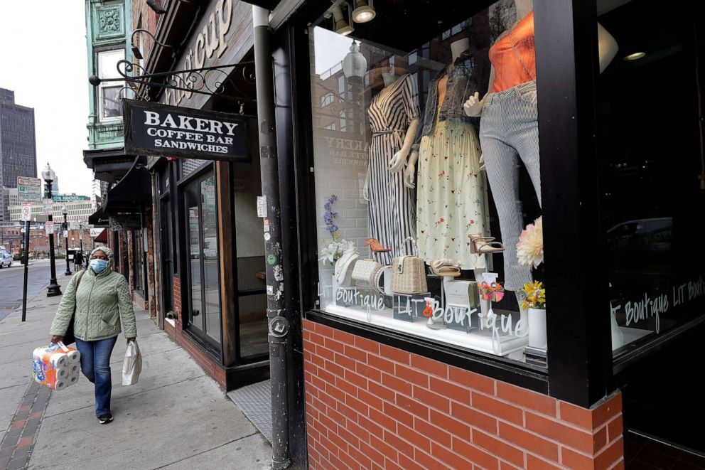 PHOTO: A pedestrian strolls past a fashionable boutique in the North End neighborhood of Boston, March 24, 2020.
