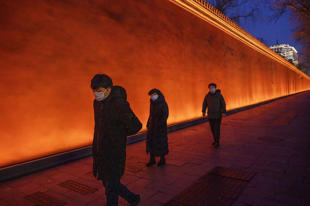 PHOTO: People wear protective masks as they walk in an area usually busy with tourists near Tiananmen Square, Feb. 28, 2020 in Beijing