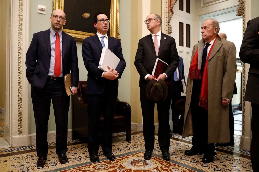 PHOTO: Treasury Secretary Steve Mnuchin, center left, speaks with reporters as he departs a meeting with Senate Republicans on an economic lifeline for Americans affected by the coronavirus outbreak on Capitol Hill in Washington, March 16, 2020.