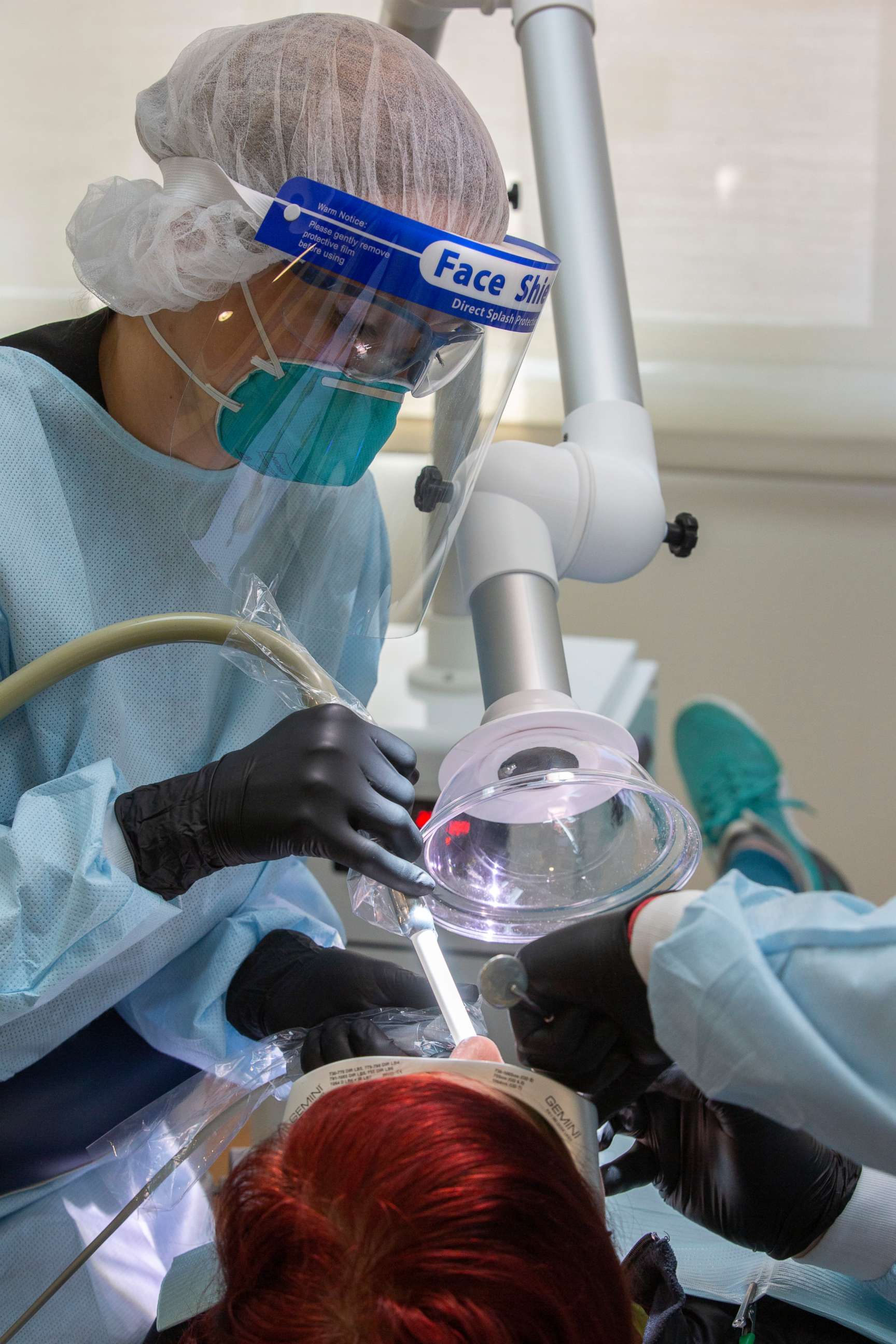 PHOTO: Dental professionals progress through a dental procedure on a patient at Bloom Dental Group on May 15, 2020, in San Mateo, Calif.