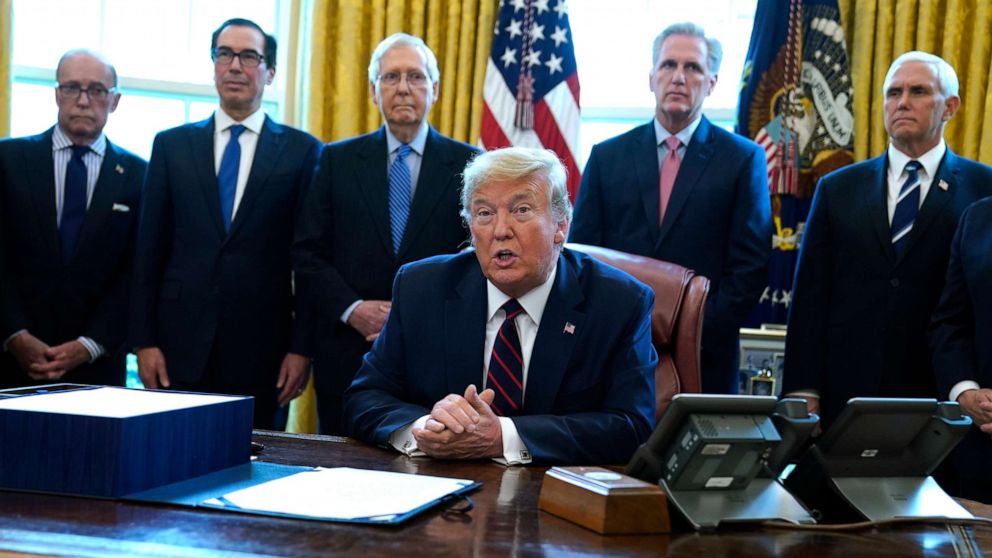 PHOTO: President Donald Trump speaks before he signs the coronavirus stimulus relief package in the Oval Office at the White House, Friday, March 27, 2020, in Washington.