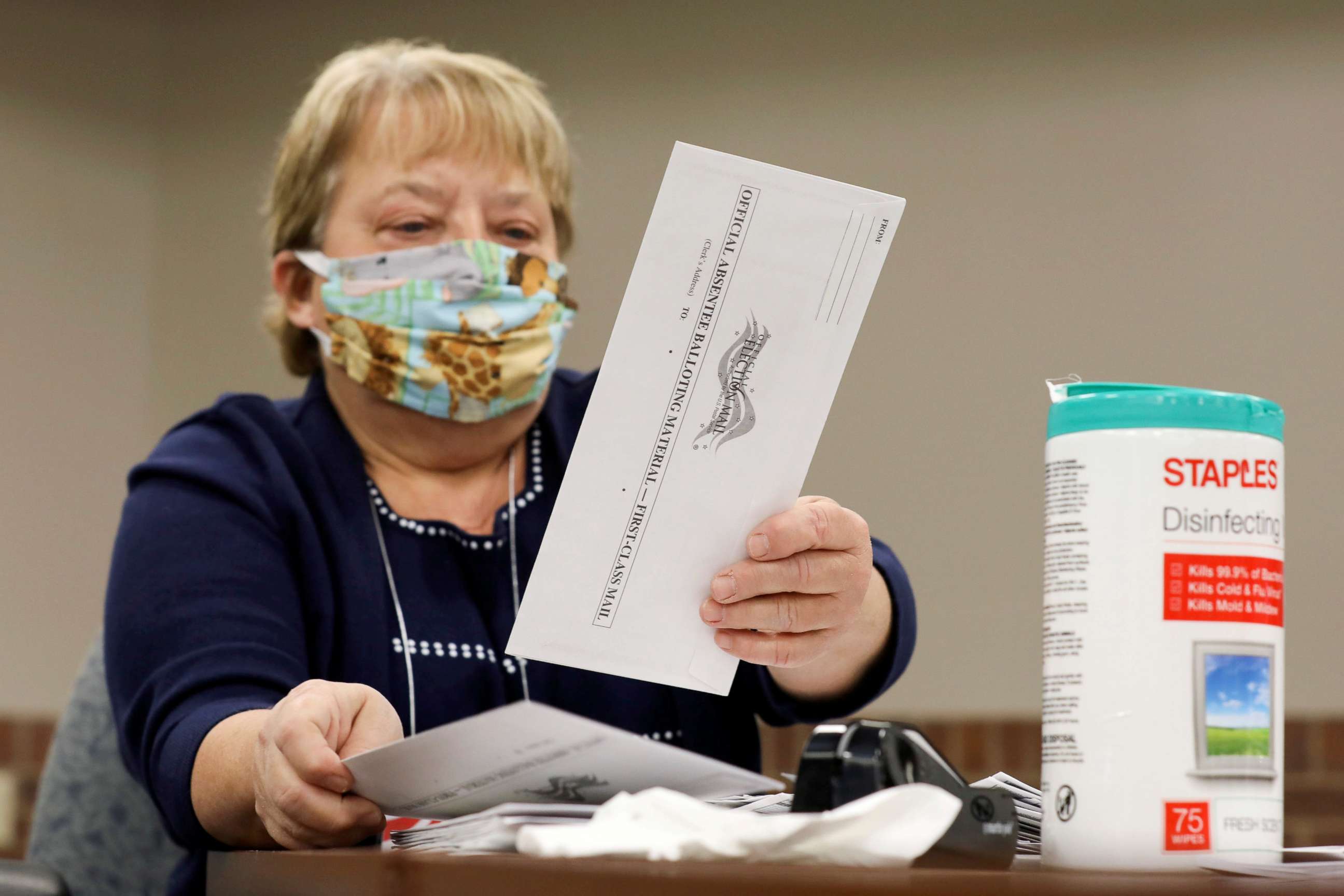 PHOTO: Election volunteer Nancy Gavney verifies voter and witness signatures on absentee ballots as they are counted at the City Hall during the presidential primary election held amid the coronavirus disease outbreak in Beloit, Wis., April 7, 2020.
