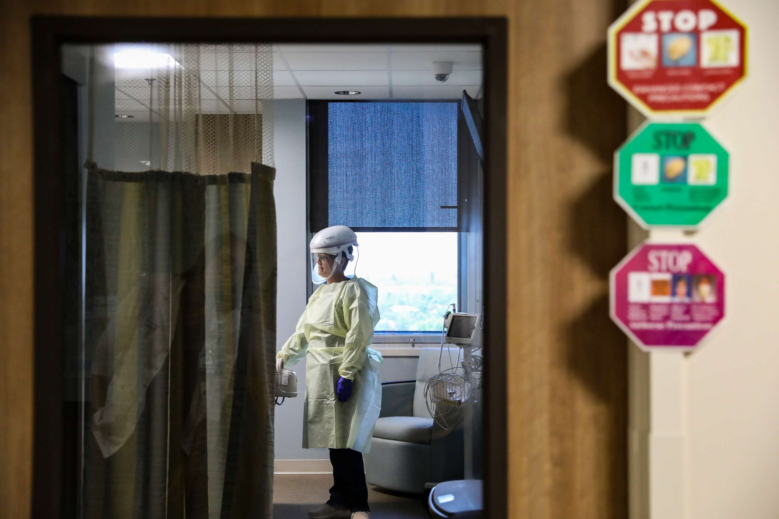 PHOTO: A nurse in a respiratory progressive care unit works with a patient in isolation at Sarasota Memorial Hospital in Sarasota, Fla., March 10, 2020.