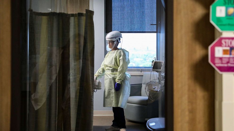 PHOTO: A nurse in a respiratory progressive care unit works with a patient in isolation at Sarasota Memorial Hospital in Sarasota, Fla., March 10, 2020.
