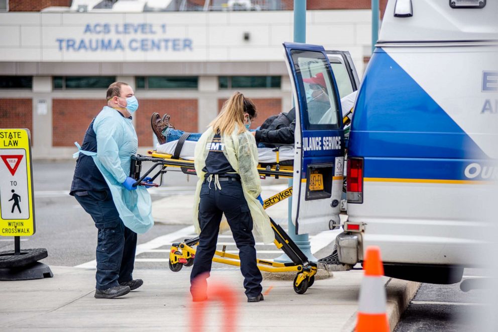 PHOTO: First responders transporting a patient outside of Winthrop Hospital in Mineola, N.Y., April 5, 2020.