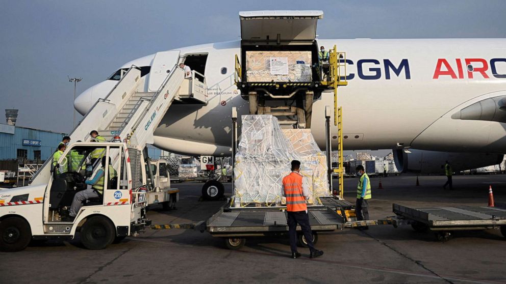 PHOTO: Ground staff unload the COVID-19 coronavirus medical supplies from France, upon the arrival of a cargo plane at the Indira Gandhi International Airport in New Delhi on May 2, 2021.