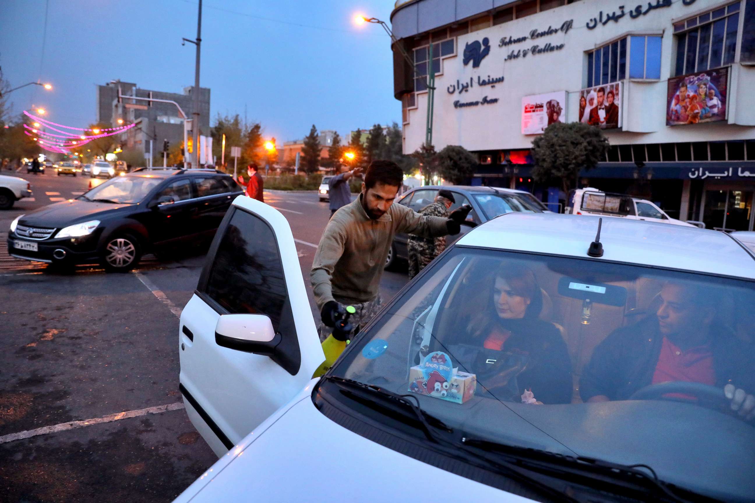 PHOTO: Iranian Revolutionary Guard and paramilitary Basij force members disinfect cars to help prevent the spread of the new coronavirus in downtown Tehran, Iran,  March 25, 2020.
