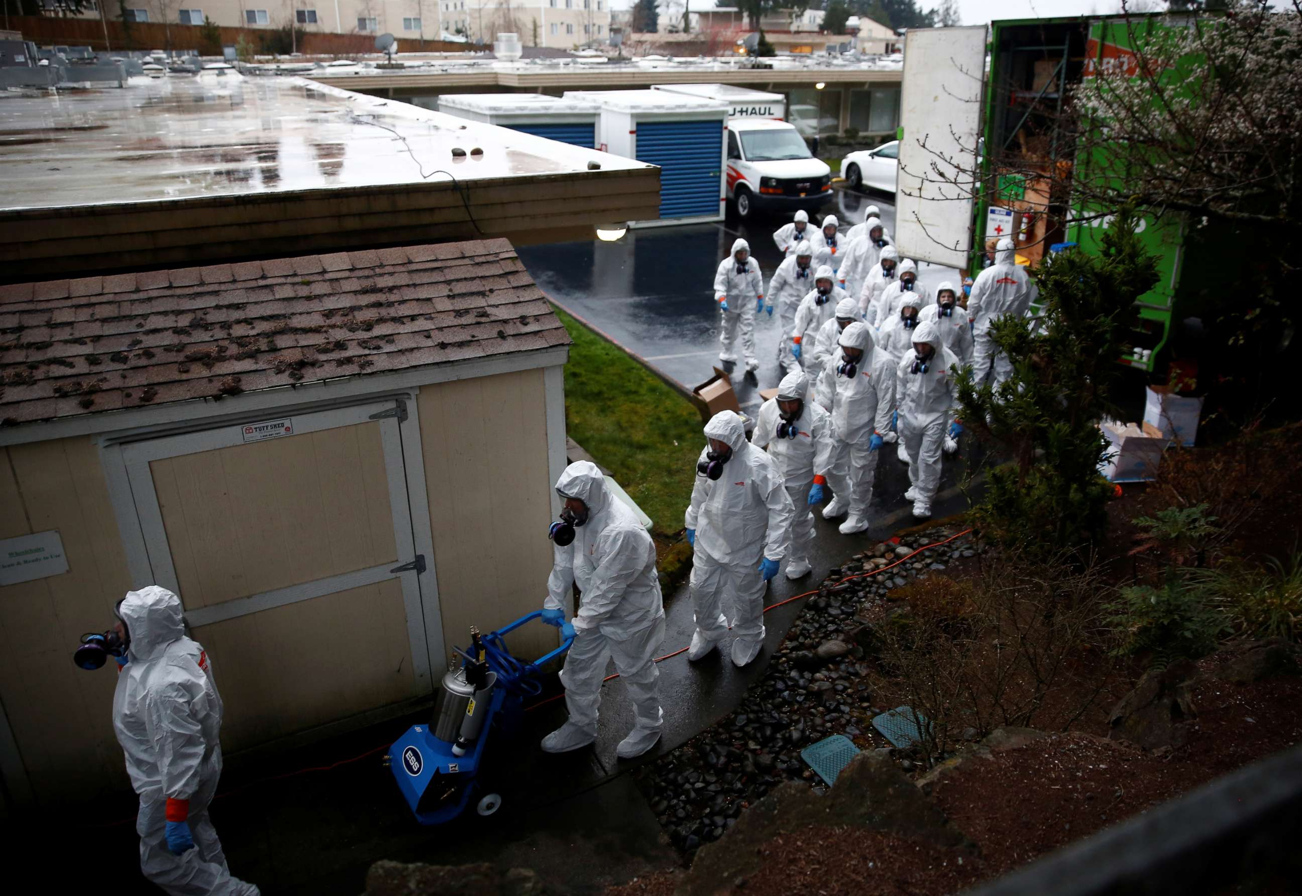 PHOTO: Servpro workers file in to begin a third day of cleaning at Life Care Center of Kirkland, a long-term care facility linked to several confirmed coronavirus cases, in Kirkland, Wash., March 13, 2020.