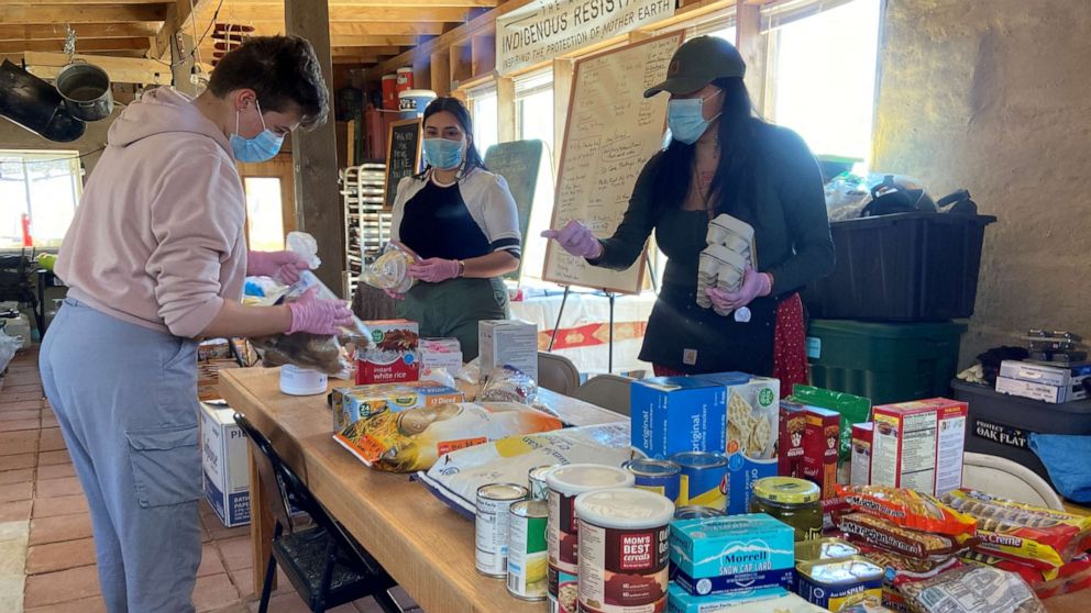 PHOTO: Relief workers prepare supplies at a farm, used as a base for aid to Navajo families quarantined in their homes due to the coronavirus disease near Shiprock, N.M., April 7, 2020.