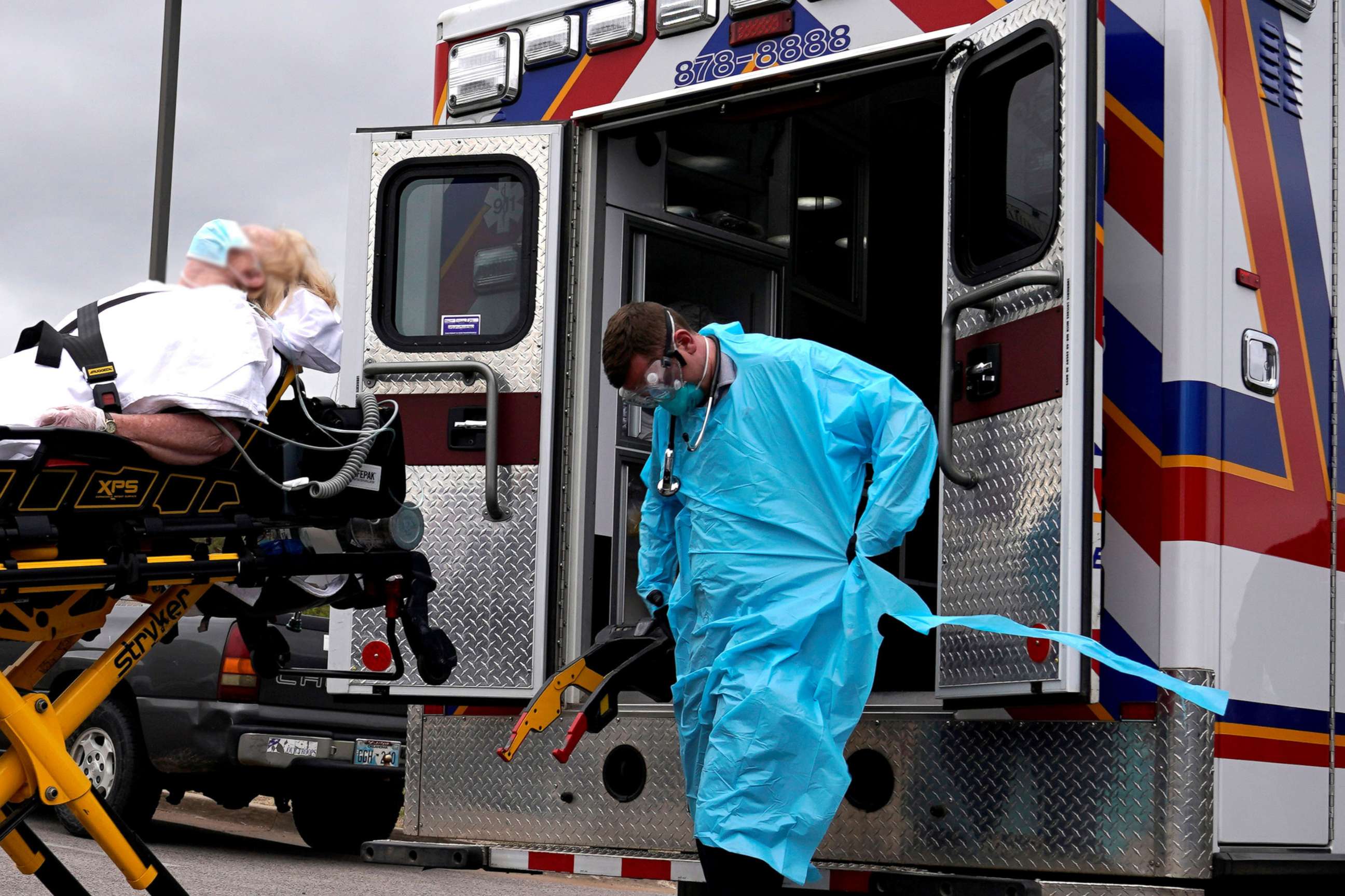 PHOTO: In this April 2, 2020, file photo, EMS paramedics wearing protective gear load a potential coronavirus disease patient for transport in Shawnee, Okla.