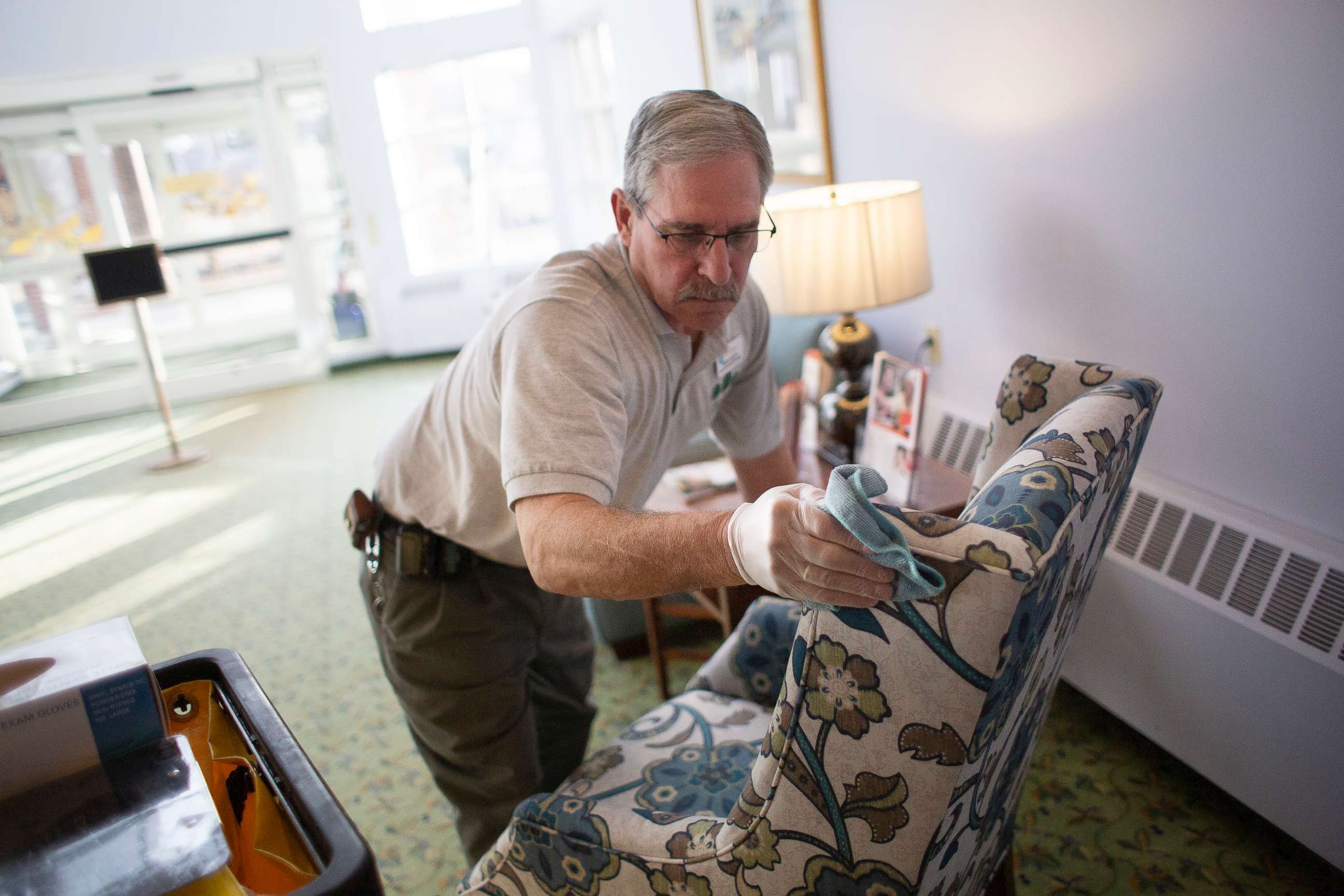 PHOTO: A man uses disinfecting spray to clean surfaces at The Cedars Hoffman Center nursing home in Portland, Maine, March 12, 2020.