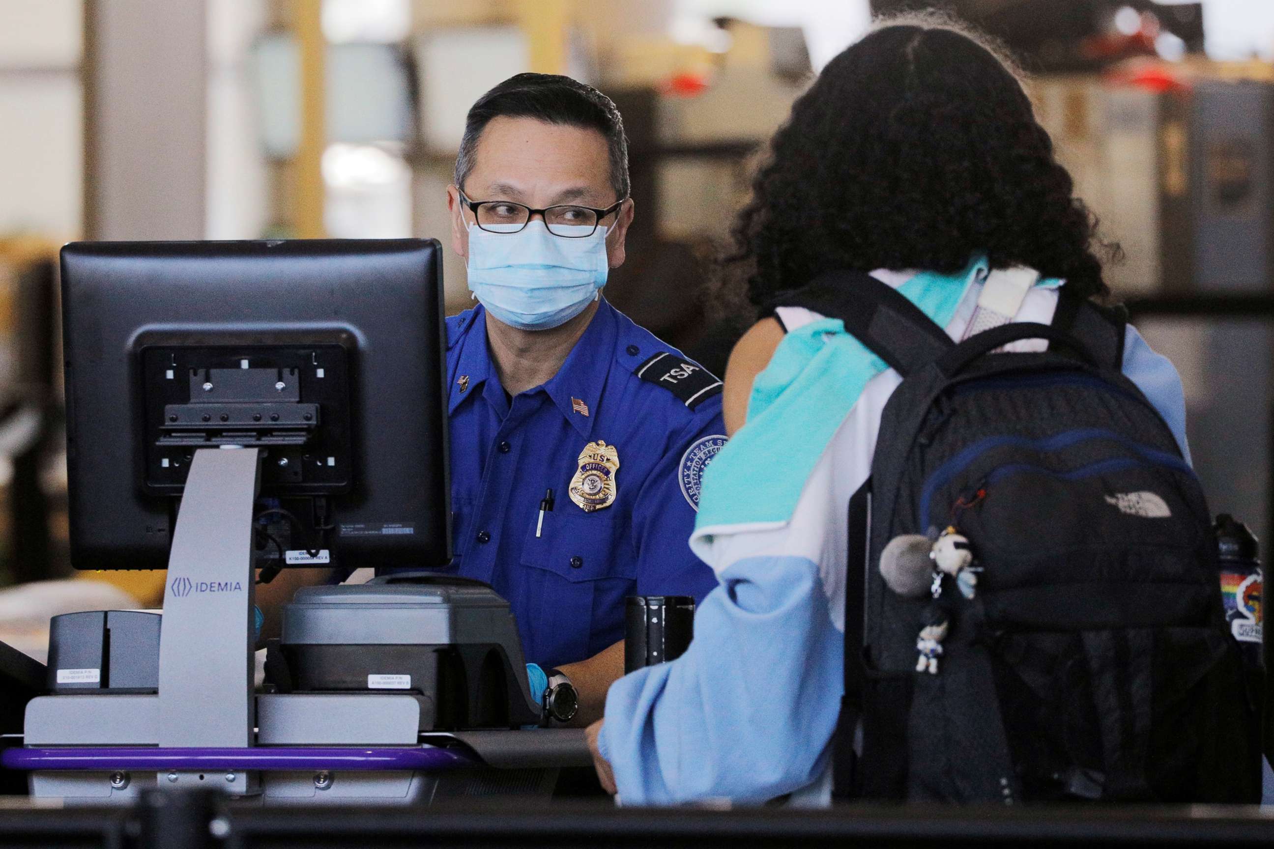 PHOTO: A TSA officer wears a mask, amid the worldwide coronavirus outbreak, at Logan International Airport in Boston, March 11, 2020.