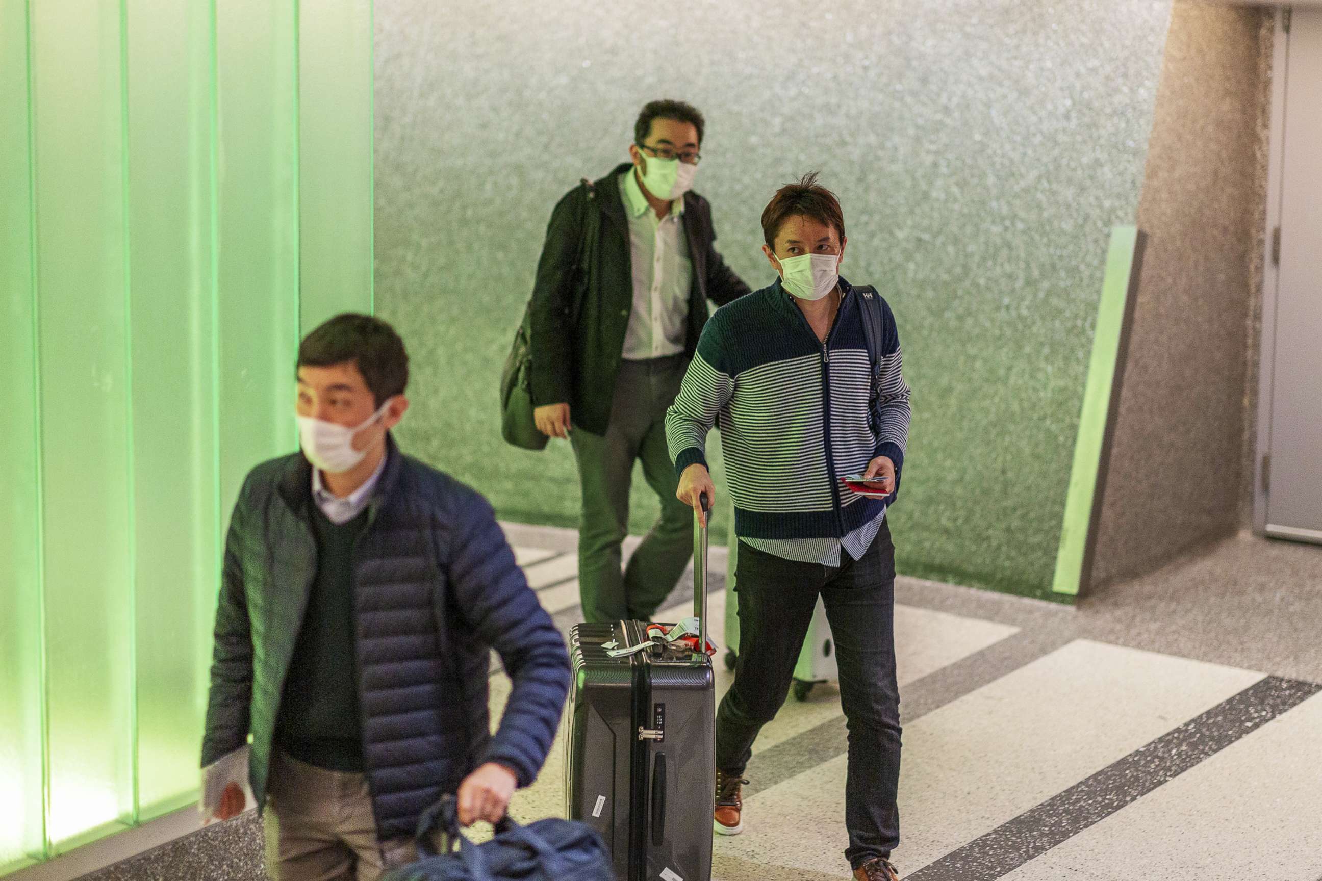 PHOTO: Travelers arrive to LAX Tom Bradley International Terminal wearing medical masks for protection against the novel coronavirus outbreak, Feb. 2, 2020 in Los Angeles.