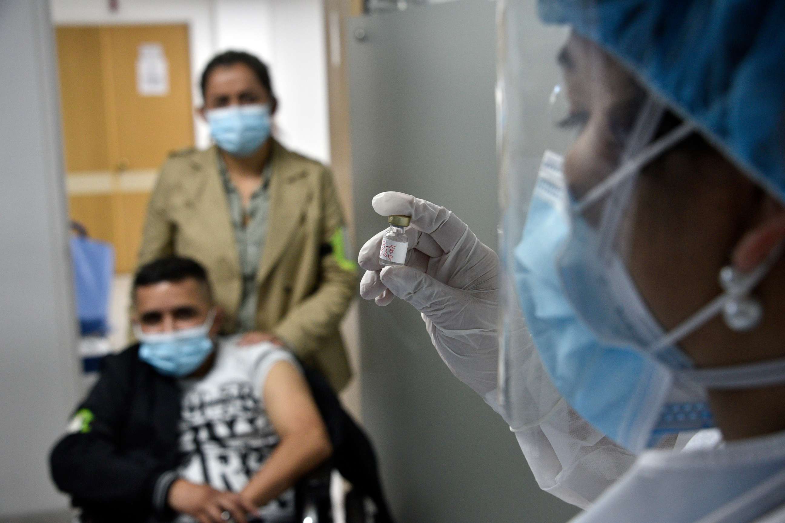 PHOTO: A health worker holds a dose during a vaccination drill before the arrival of the COVID-19 vaccine at Patio Bonito Tintal hospital on Jan. 26, 2021, in Bogota, Colombia.