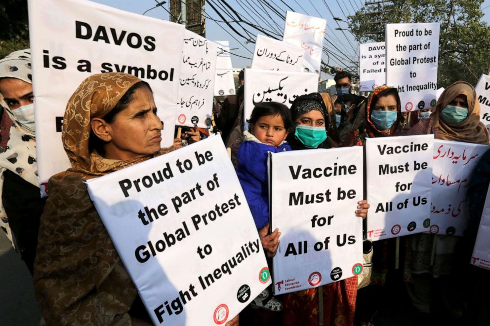 PHOTO: Women hold placards to demand fair distribution of vaccines to developing countries during a protest in Lahore, Pakistan, Jan. 29, 2021.
