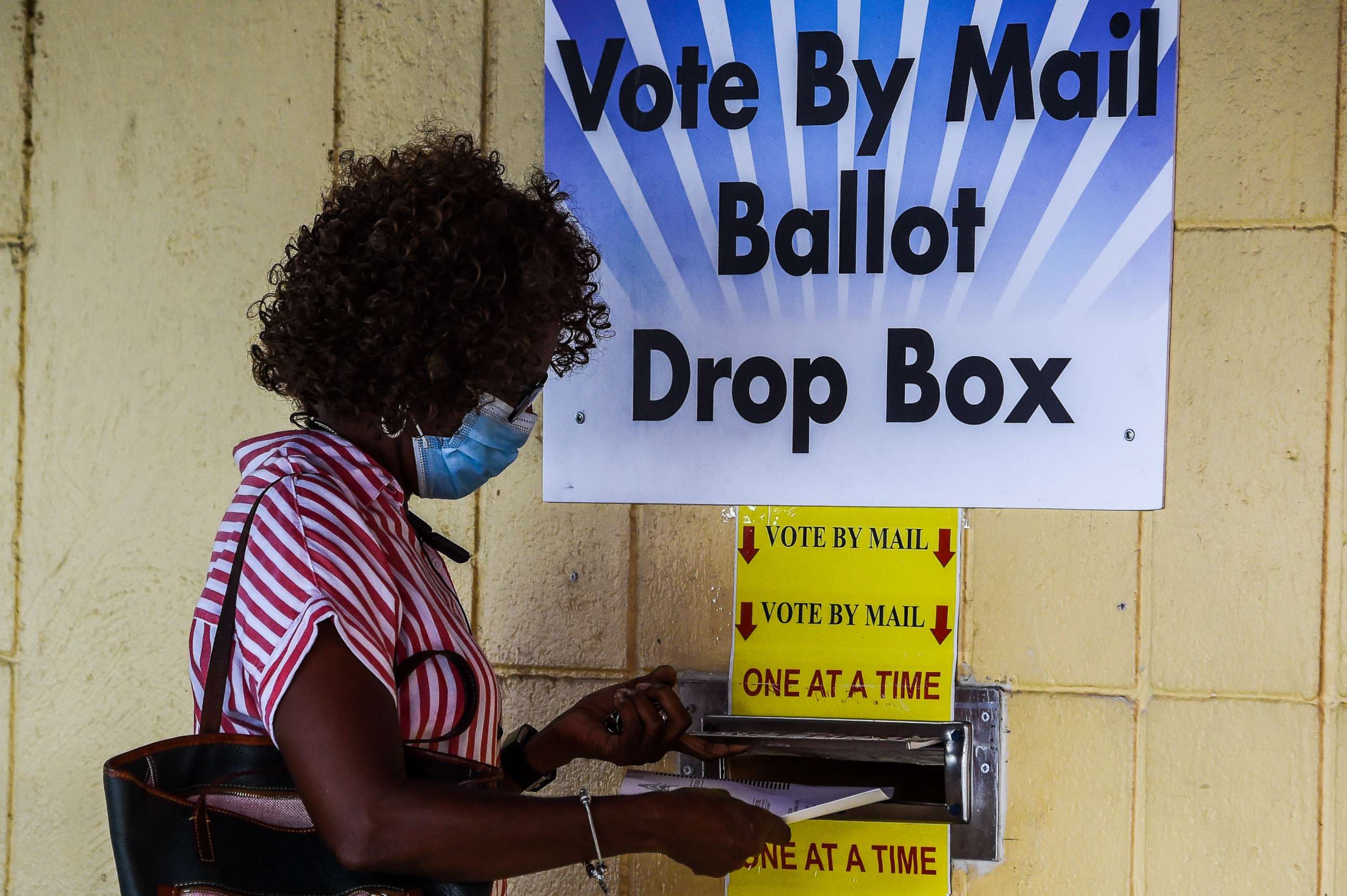 PHOTO: A woman drops her ballot by mail at Broward County Supervisor Of Elections Office in Lauderhill, Fla., Oct. 5, 2020.