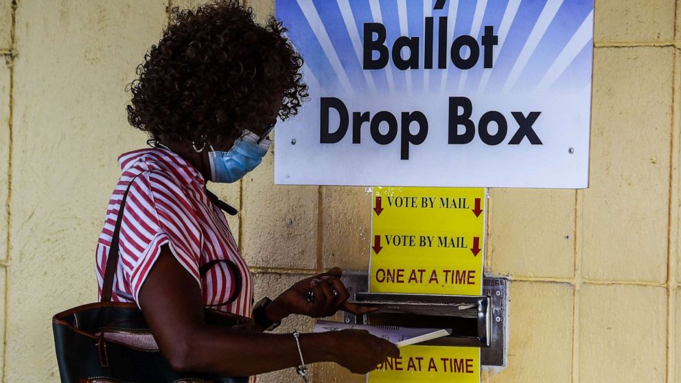 PHOTO: A woman drops her ballot by mail at Broward County Supervisor Of Elections Office in Lauderhill, Fla., Oct. 5, 2020.