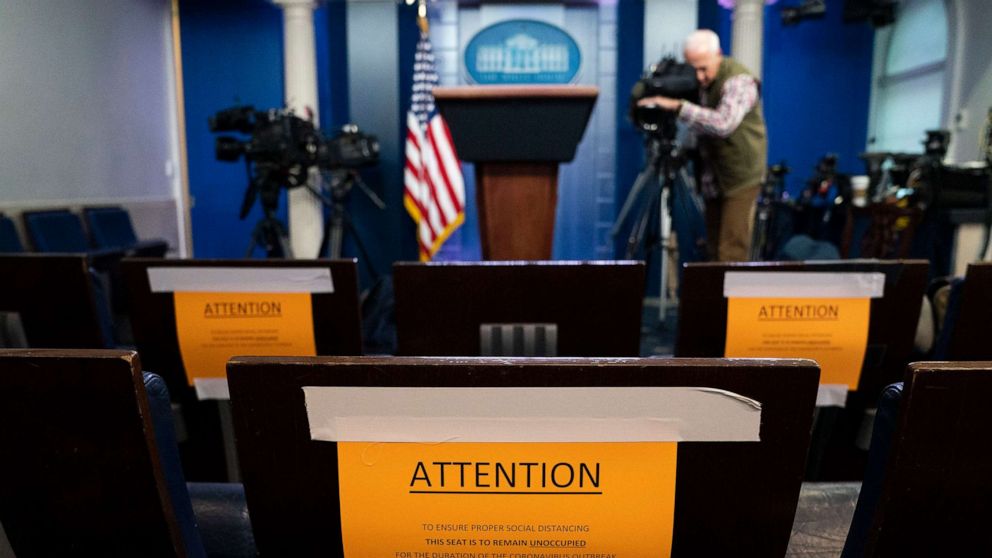 PHOTO: Signs in the briefing room of the White House indicate social distancing measures being taken to separate reporters working at the White House, March 16, 2020, in Washington.
