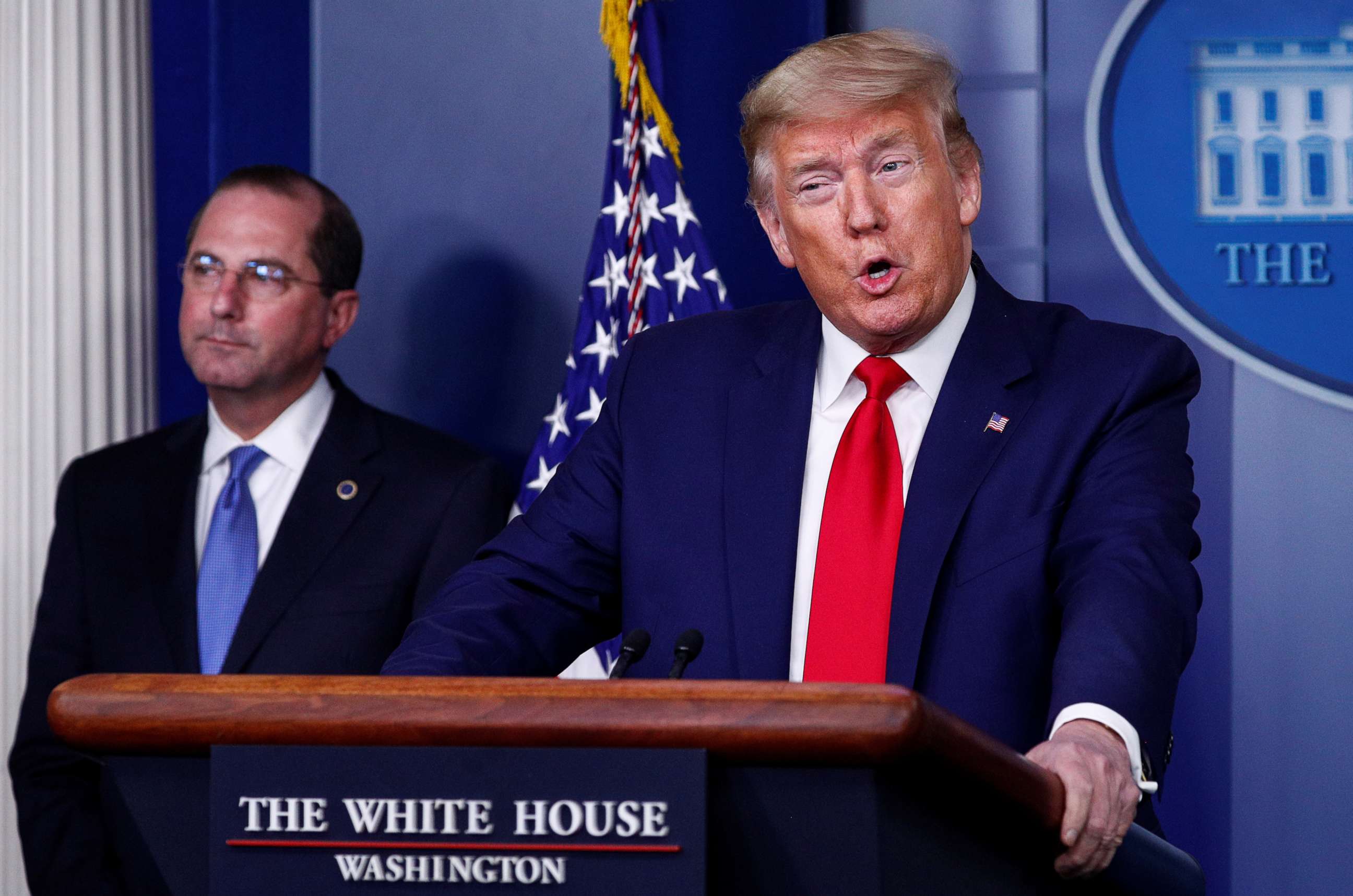 PHOTO: President Donald Trump addresses the daily coronavirus task force briefing as Health and Humand Services Secretary Alex Azar listens at the White House in Washington, April 3, 2020.
