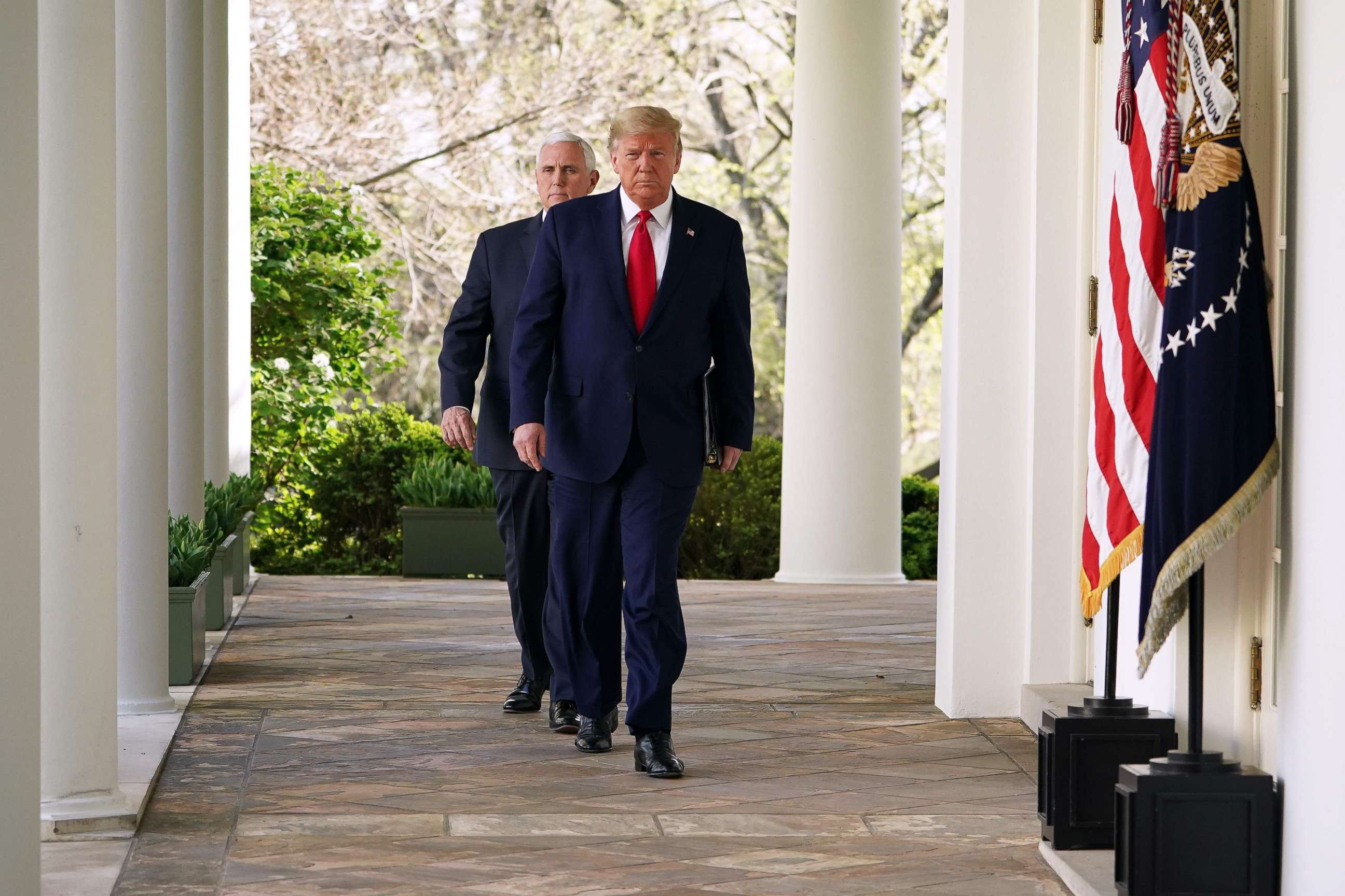 PHOTO: President Donald Trump and Vice President Mike Pence walk to deliver the daily briefing on the novel coronavirus, COVID-19, in the Rose Garden of the White House in Washington, March 30, 2020.
