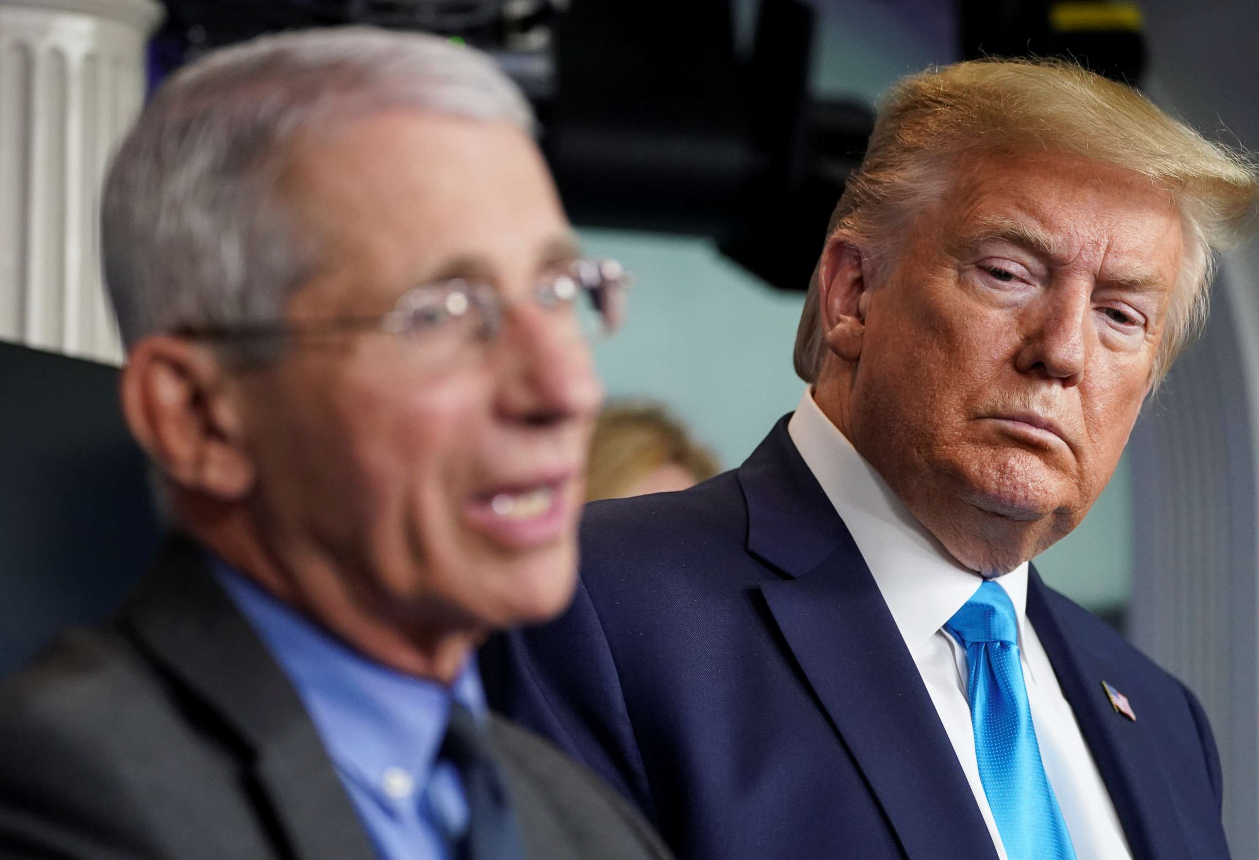PHOTO: President Donald Trump listens as Dr. Anthony Fauci, director of the National Institute of Allergy and Infectious Diseases, addresses the daily coronavirus task force briefing at the White House in Washington, April 7, 2020.