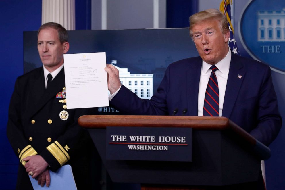 PHOTO: President Donald Trump holds up letter from the White House physician noting that he tested negative in a COVID-19 test he took earlier in the day, in the James Brady Press Briefing Room of the White House, April 2, 2020, in Washington.