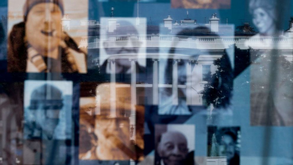 PHOTO: The White House is seen through pictures of people that died due to COVID-19 at the National COVID-19 Remembrance, on the ellipse behind the White House in Washington, Oct. 4, 2020.